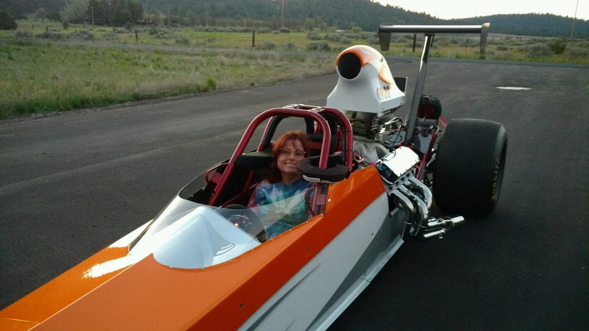 Dean Kelly Peterson-Fairchild smiles for a photo in her drag car that she races in her spare time. Photo courtesy of Kelly Peterson-Fairchild.