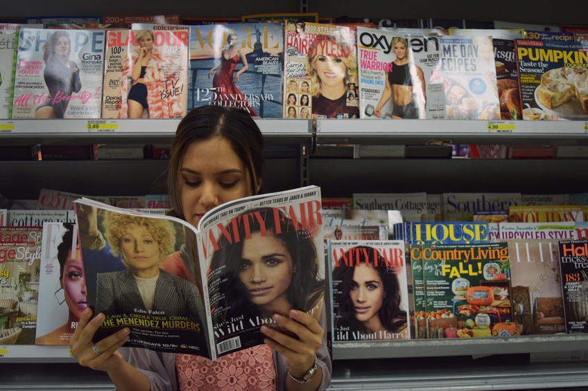 Julia Aguayo, a junior communications major from Las Vegas, picks up the latest issue of Vanity Fair magazine to ensure that she knows the latest fashion trends. Photo by Camden Bennett.